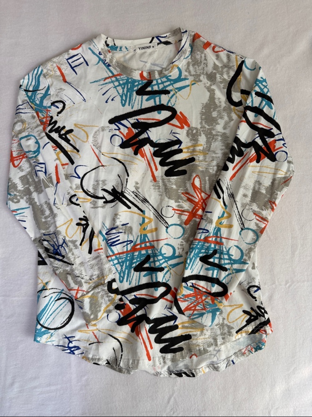 YININF Abstract Scribble Crewneck Tee in White with Teal & Coral Accents